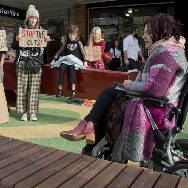 Amy Taylor (right), of Mosgiel, speaks at a disability funding protest in the George St play...