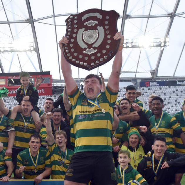Green Island captain Heath MacEwan celebrates his team winning the premier club rugby final...
