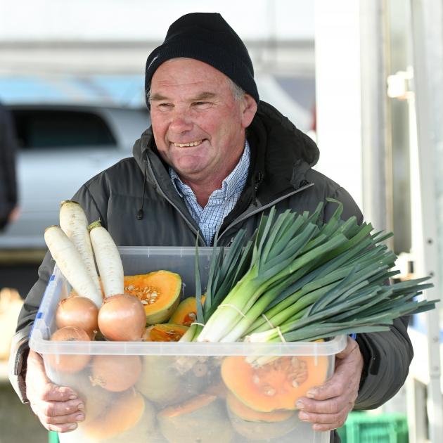 Busman’s holiday ... Jeffrey Bruce at work selling vegetables at the Otago Farmers Market in...
