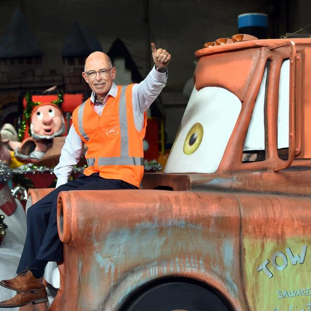 Dunedin Santa Parade Trust chairman John Marsh sits on the bonnet of the Tow Mater float...