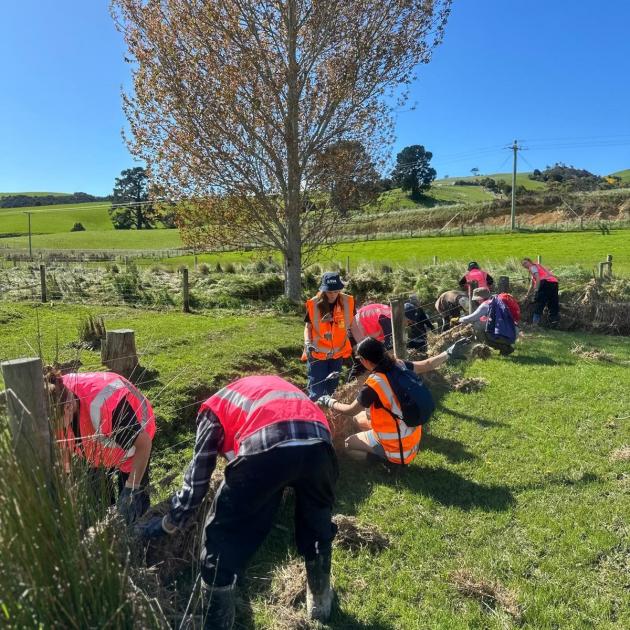 Volunteers from Otago Student Volunteer Army, UniCrew and Volunteer South clean flood debris from...