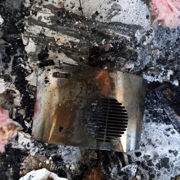 The charred remains of a Serene bathroom heater after a house fire in Christchurch. Photo: Fenz
