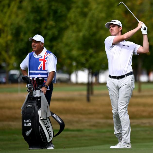Daniel Hillier plays a shot at the New Zealand Open at Millbrook as caddy Steve Williams keeps a...