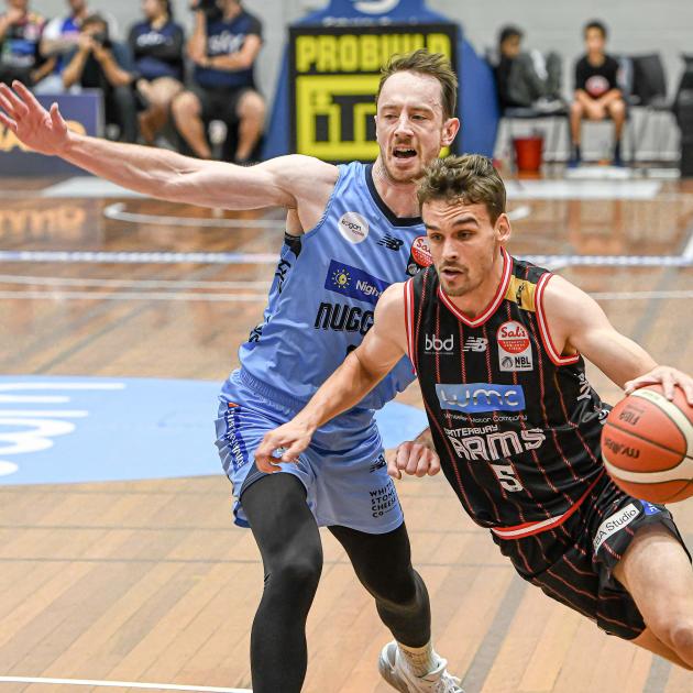 Canterbury Rams guard Taylor Britt slips around Otago Nuggets captain Darcy Knox during a...