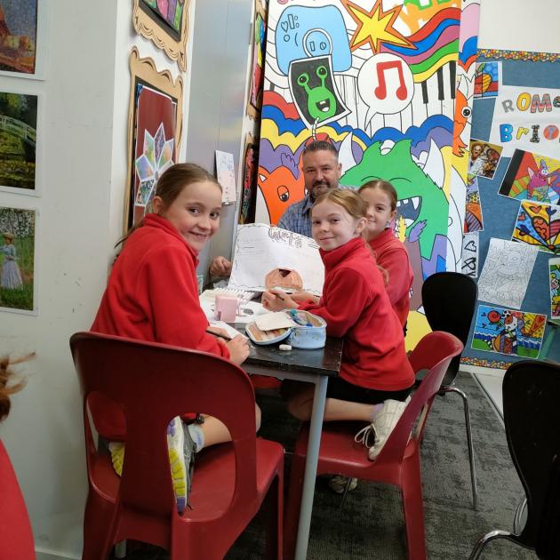 Kaiapoi North School students Bonnie (9, left), Alyssa (10) and Indi (10) show principal Jason...