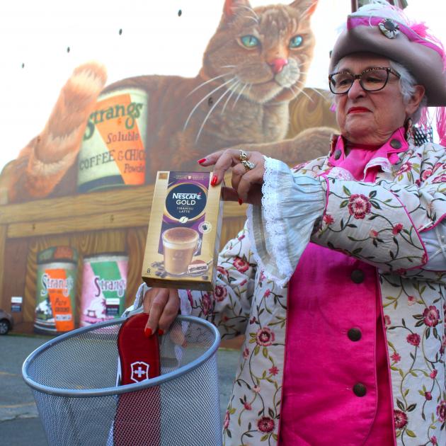 Invercargill town crier Lynley McKerrow in front of a Strang’s Coffee mural shows what she thinks...