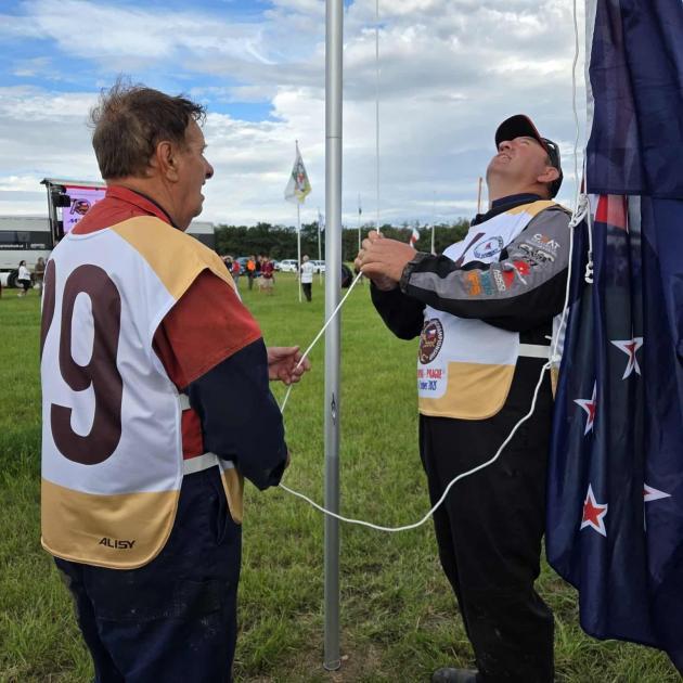 Southern ploughmen Bob Mehrtens (left) and Mark Dillon raise a New Zealand flag at the 70th World...