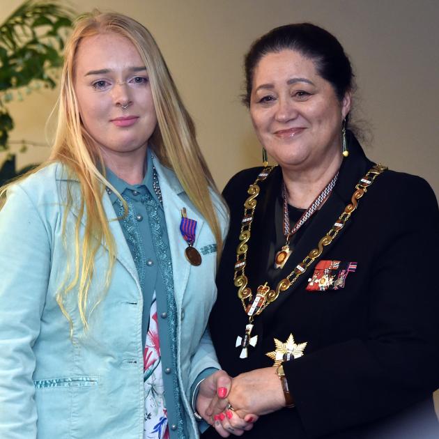 Standing with Governor-general Dame Cindy Kiro is New Zealand Bravery Medal recipient Hope Clayton.
