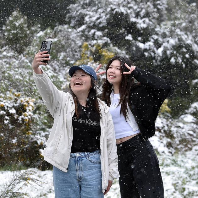 Wen Chao (left) and Maggie Lin, both of Christchurch, take a selfie in the snow at Leith Saddle...