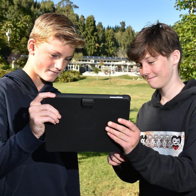 Ethan Defountain (12) (left) and Hazel Ross (12) use the Blueskin Energy Network (BEN) app to...