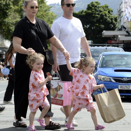Dunedin residents Hannah and Dyson Freeman cross George St with their 2-year-old twin daughters...