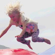 Bouncing . . . Mia Smith (then 6) plays on an inflatable at last year’s gala day. PHOTOS: THE...