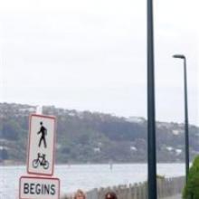 Jan Landmann (left) and Sarah Manning are dwarfed by the 6m cycleway lampposts as they walk past Maia last week. Photo by Stephen Jaquiery.