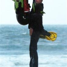 Greg Clark is rescued from the surf off Taieri Island by Water Rescue Squad member Paul Sharp.
