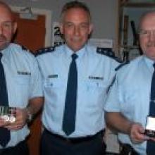 Inspector Dave Campbell (centre) congratulates two long-serving South Otago police officers, Senior Constable Robert Wallace, of Lawrence, (left) and Senior Sergeant Richard Whitmore, of Balclutha. Photo by Glenn Conway