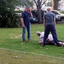University of Otago deputy proctor Andrew Ferguson restrains a man on nearby Logan Park. University of Otago deputy proctor Andrew Ferguson restrains a man on nearby Logan Park.