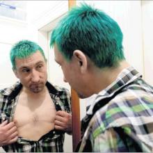 Lung transplant recipient Rupert Greenwood looks at his scars in a mirror yesterday after...