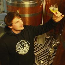 Wanaka Beerworks head brewer Andrew Boulton inspects the clarity of a new batch of the brewery’s...