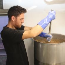 Ground Up brewery co-owner Oli Boyes combines malt and water at the start of a new brew, using...