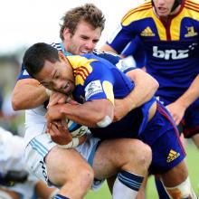 Soakai tries to barge his way through the tackle of the Blues’ Jarred Payne during a pre-season...