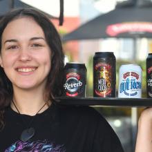 Emerson’s Brewery employee Myah Darning with the brewery’s four award-winning beers. PHOTO:...