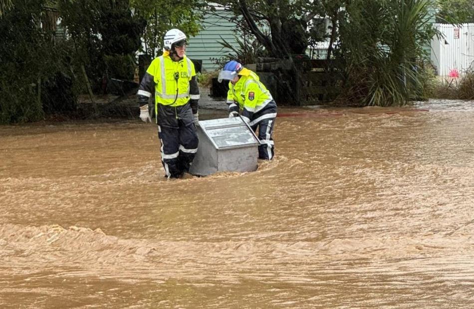 Firefighters wade through flooding in Little River. Photo: Little River Volunteer Fire Brigade