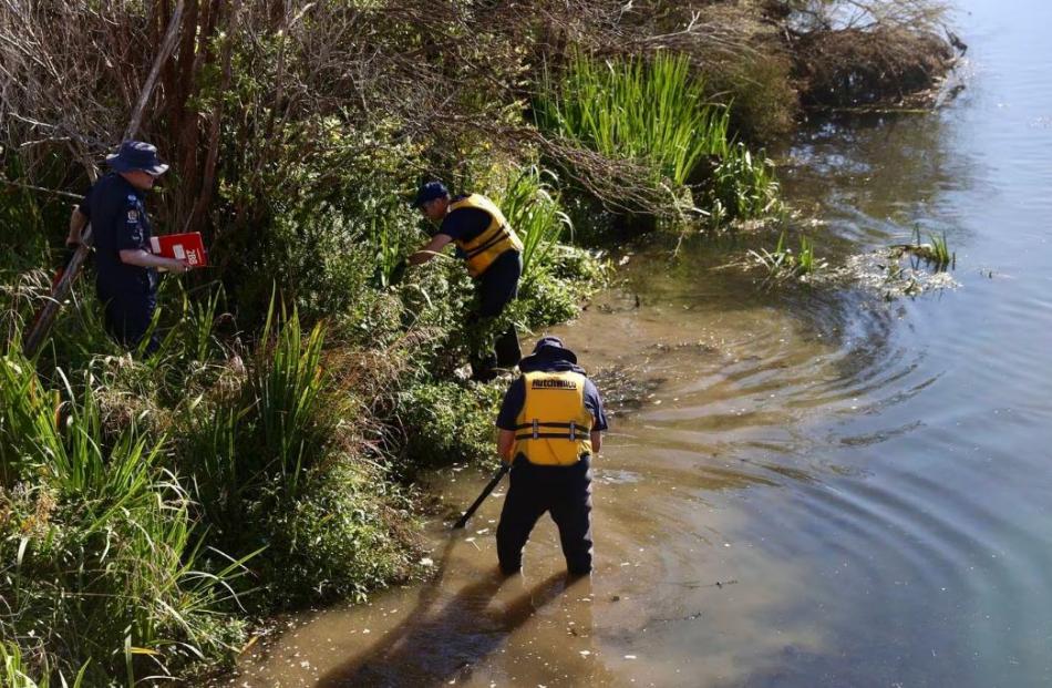Police search the Avon River banks. Photo: George Heard