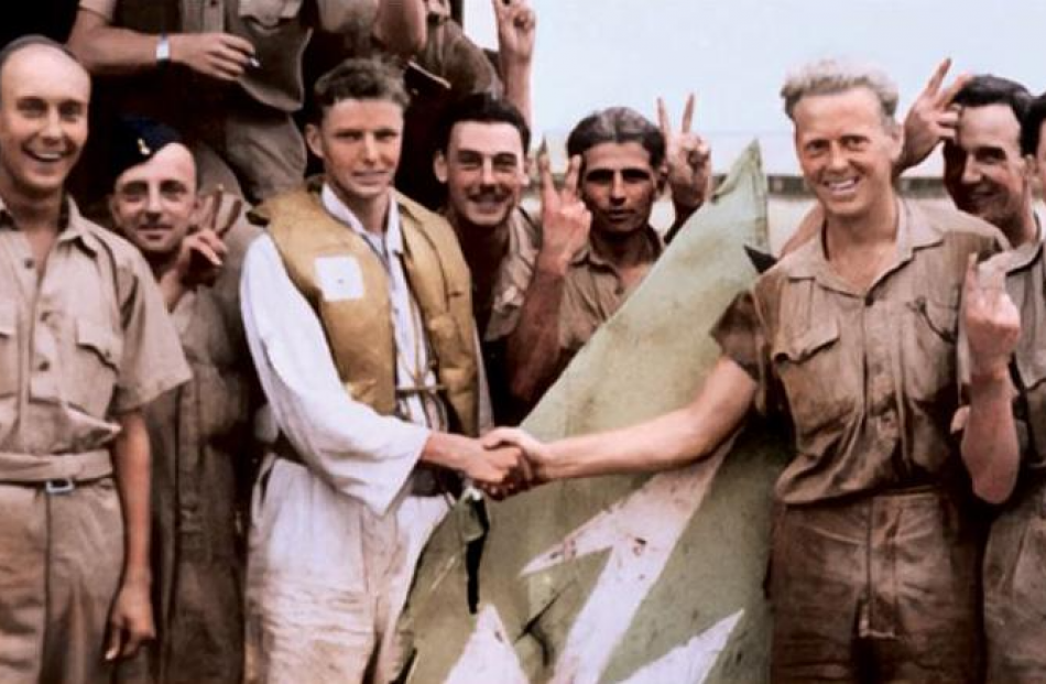 Sergeant Charlie Kronk (third from left) is congratulated by other members of No 243 Squadron...