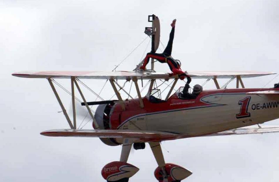 Wing walker Peggy Krainz performs at the airshow while her partner Friedrich Walentin flys the...