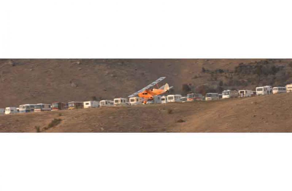 A fox moth does an early buzz past the line of campervans which camp on the hill overlooking the...