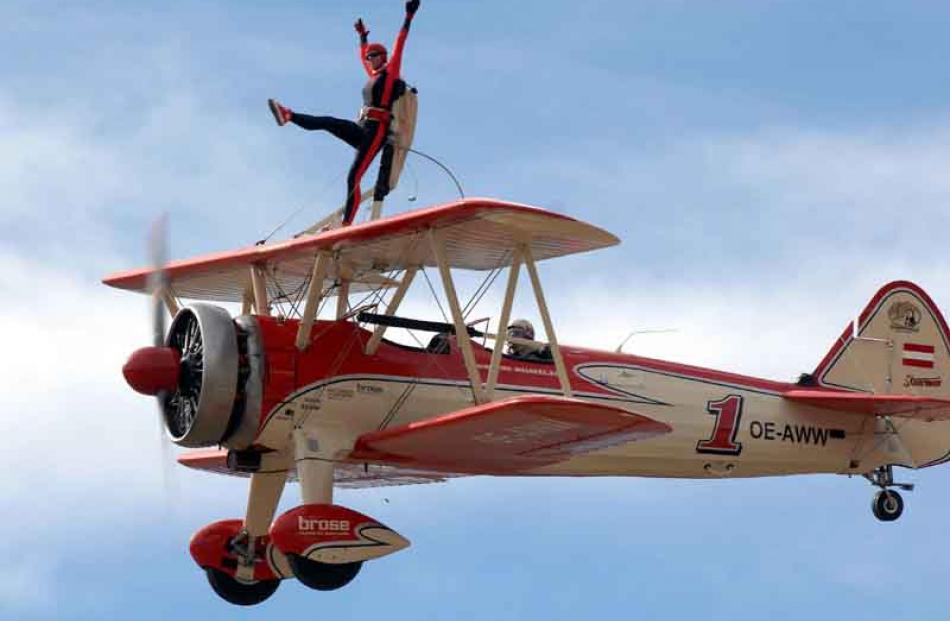 Wing walker Peggy Krainz performs at the airshow while her partner Friedrich Walentin flys the...
