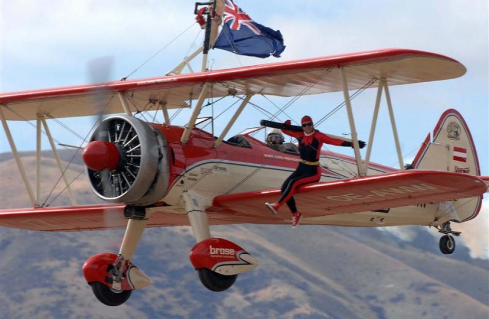 Ms Krainz goes through her paces at the Warbirds Over Wanaka airshow yesterday while Mr Walentin...