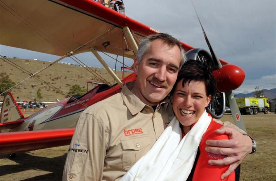 Wing walker Peggy Krainz, of Germany, smiles with partner and pilot Friedrich Walentin. Photos by...