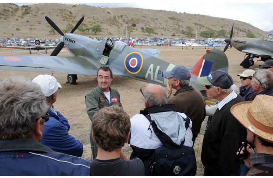 Supermarine Spitfire pilot, John Lanham, chats to a small crowd of admirers after his display...