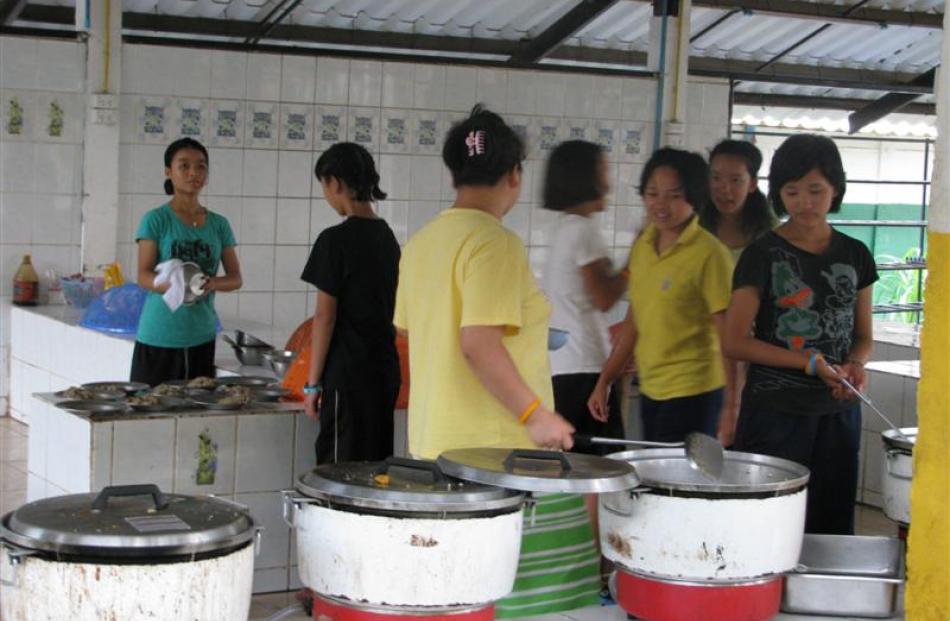 Young members of the Akha tribe in the kitchen of the rescue mission's training centre.