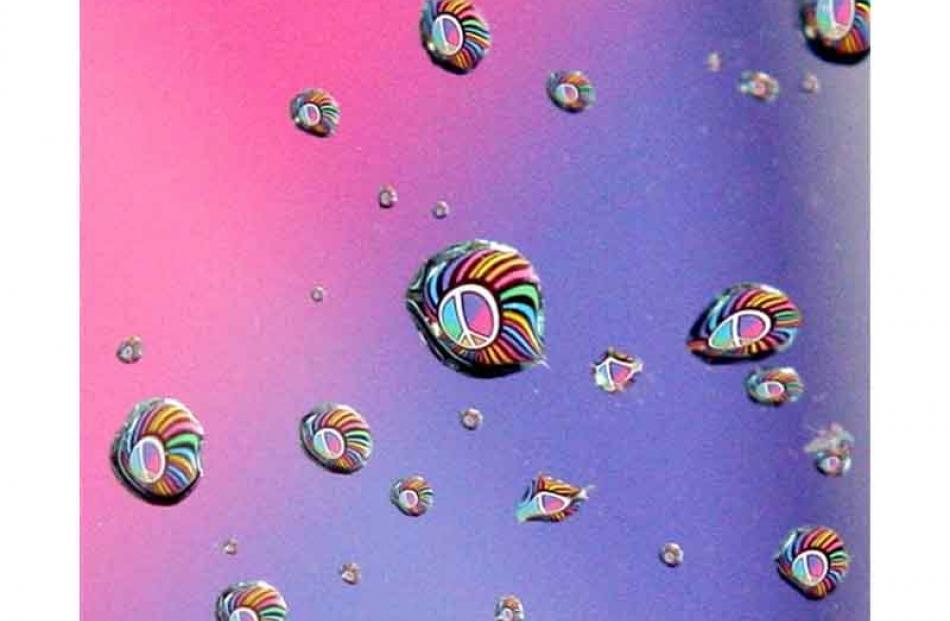 A peace activist's flag is refracted in the raindrops of a car windshield at Fort Smith, Arkansas.