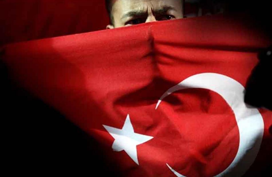 A supporter of newly-elected Turkish Cypriots' leader Dervis Eroglu celebrates in the Turkish...