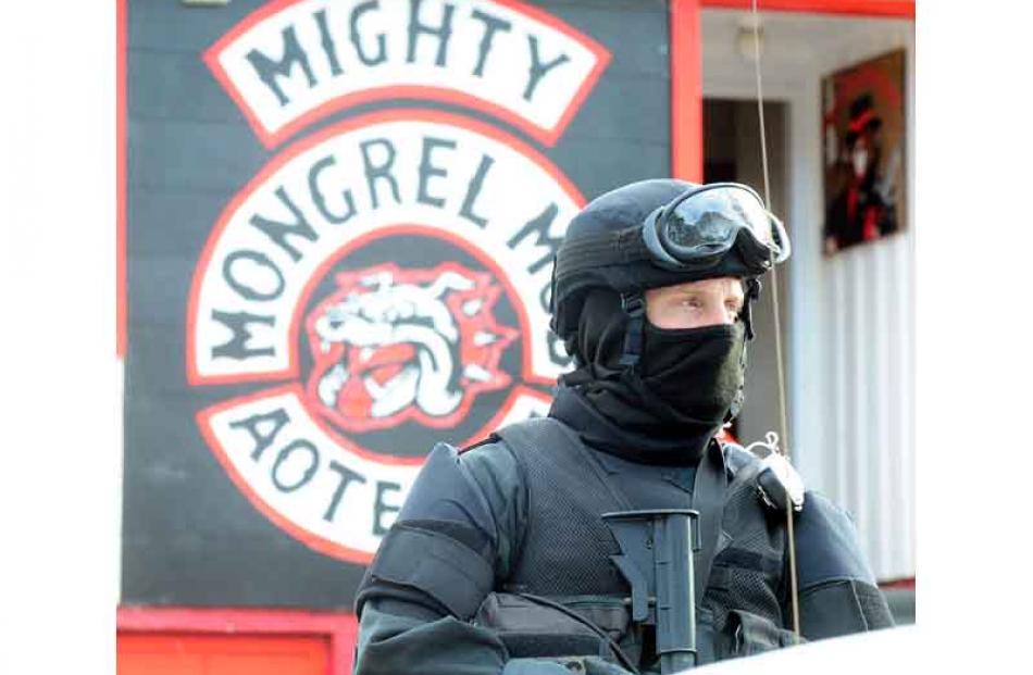 An Armed Offenders Squad member stands guard outside the former Mongrel Mob Aotearoa headquarters.