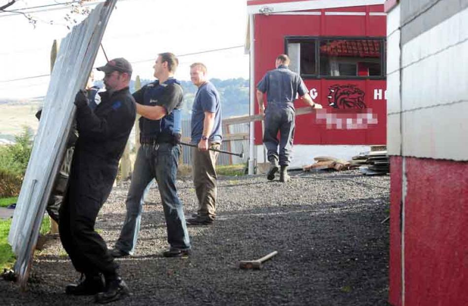 Police demolish another section of fence from the former Mongrel Mob Aotearoa headquarters.