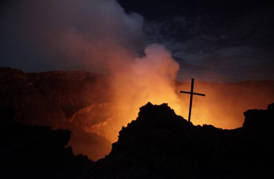 A cross marks the spot at the edge of Mount Nyiragongo's crater where a Chinese tourist fell to...