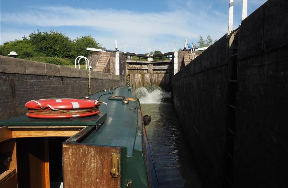 Water surges through the paddles at the bottom of the lock gates. 