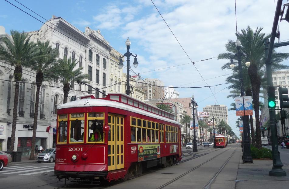 Streetcars travel down New Orleans’ bustling Canal St. Photos: Pam Jones.