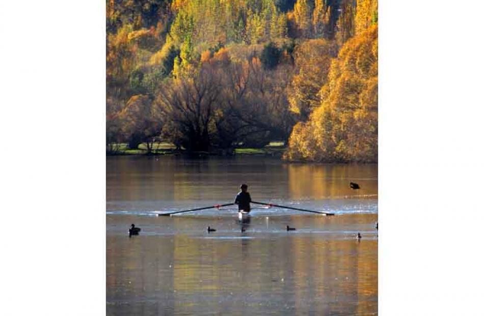 A rower makes the most of a picture-perfect autumn day at Lake Hayes. Photo by Tracey Roxburgh