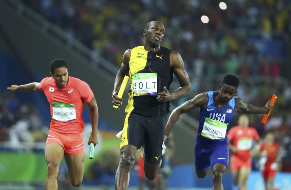Usain Bolt (centre) at the finish line ahead of Japan's Aska Cambridge and Trayvon Bromell from the US. Photo: Reuters 