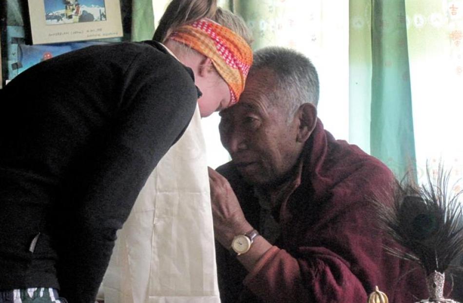 Lucy is blessed by the Llama Geishe (viewed as a reincarnated god by Sherpa people). Photos...