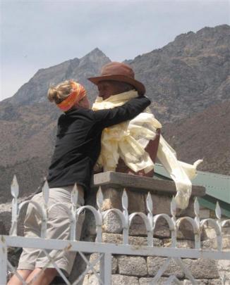 Lucy places a blessing scarf around the statue of Sir Edmund Hillary in Nepal.