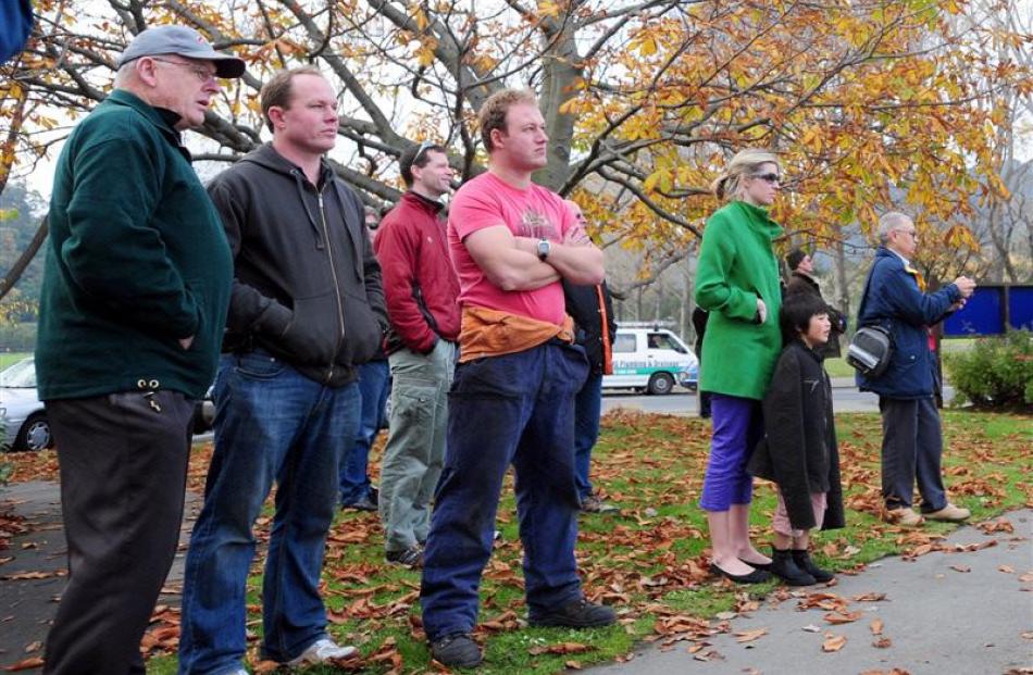 Onlookers watch the delicate operation.