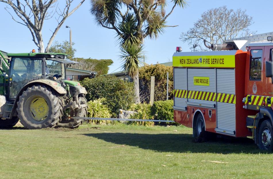 Farmer Evan Hurst uses his tractor to free the appliance.
