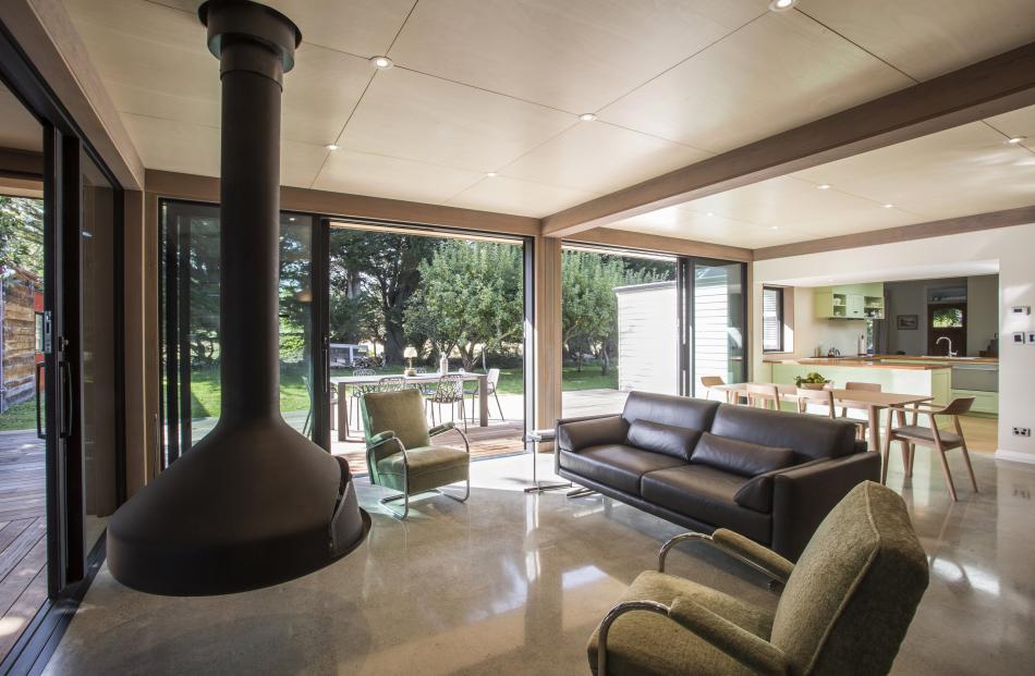 The extension has triple glazing and an insulated concrete floor that acts as a thermal mass for...