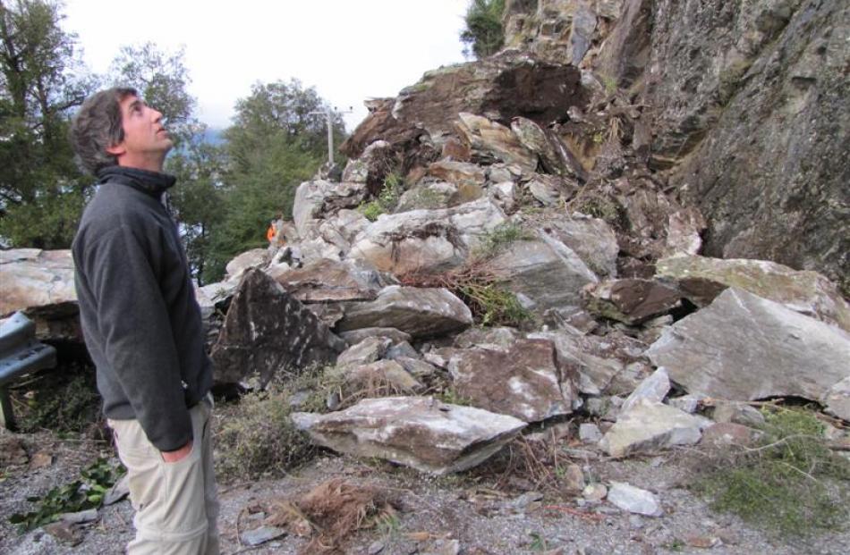 Queenstown resident Chris Johnson surveys the rockslide which spoiled his group's plans to go...